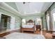 This is a large main bedroom with hardwood floors and a trey ceiling at 385 Liberty Church Rd, Carrollton, GA 30116