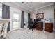 Home office features large windows, tile flooring, and functional desk and storage at 385 Liberty Church Rd, Carrollton, GA 30116