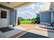 Covered patio with brick trim, hammock, and outdoor seating overlooking a green lawn at 385 Liberty Church Rd, Carrollton, GA 30116