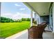 Inviting covered porch with comfortable seating overlooking the well-manicured backyard and landscaping at 385 Liberty Church Rd, Carrollton, GA 30116