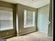 Neutral bedroom with blinds, two windows, and carpeted floors for comfortable living at 5057 Windsor Forrest Lane, Atlanta, GA 30349