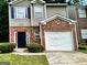 Charming two-story home with brick accents and a well-manicured front yard at 5057 Windsor Forrest Lane, Atlanta, GA 30349