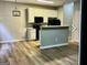 Cozy kitchen featuring white cabinets, a breakfast bar, and modern black appliances for convenient cooking at 5057 Windsor Forrest Lane, Atlanta, GA 30349