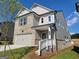 The side of this home is gray vinyl siding and gray brick, featuring a two-car garage at 35 Fraser Ln # 123B, Auburn, GA 30011