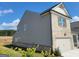 Side of gray vinyl siding and gray brick home featuring a two-car garage at 35 Fraser Ln # 123B, Auburn, GA 30011