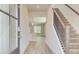Entryway featuring an open concept view, a staircase, and hard surface floors at 35 Fraser Ln # 123B, Auburn, GA 30011