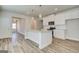 Bright kitchen boasts white cabinets, stainless appliances, granite counters and gorgeous pendant lighting at 35 Fraser Ln # 123B, Auburn, GA 30011