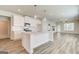 Open concept kitchen with a large island, white cabinets, and stainless steel appliances flows into living area at 35 Fraser Ln # 123B, Auburn, GA 30011
