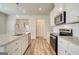 Well-lit kitchen featuring stainless appliances, granite counters, and wood-look flooring at 35 Fraser Ln # 123B, Auburn, GA 30011