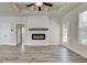 Open-concept living room featuring a fireplace, a ceiling fan, and a door to the exterior at 35 Fraser Ln # 123B, Auburn, GA 30011
