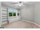 Bright bedroom with built-in shelves, storage, and a window overlooking the backyard at 205 N Strathmore Dr, Sharpsburg, GA 30277
