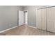 Neutral bedroom featuring wood floors, closet, and doorway leading to another room at 205 N Strathmore Dr, Sharpsburg, GA 30277