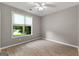 Light filled bedroom with large window offering views of backyard at 205 N Strathmore Dr, Sharpsburg, GA 30277