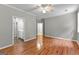 Spacious bedroom boasts hardwood floors and an ensuite bathroom at 205 N Strathmore Dr, Sharpsburg, GA 30277