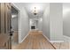 Inviting entryway with chandelier, wood-look flooring, and view of fireplace at 205 N Strathmore Dr, Sharpsburg, GA 30277