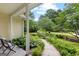 Charming front porch with lush landscaping and a walkway leading to the property at 205 N Strathmore Dr, Sharpsburg, GA 30277