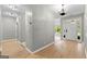 A bright hallway with hard wood floors, a chandelier, and open access to the home's entrance at 205 N Strathmore Dr, Sharpsburg, GA 30277