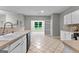 Functional kitchen overlooking a bright space with tile flooring and a large window at 205 N Strathmore Dr, Sharpsburg, GA 30277