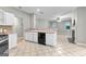Well-lit kitchen with white cabinets, tile floor, and an open view to the living areas at 205 N Strathmore Dr, Sharpsburg, GA 30277