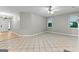 Inviting living room with tile flooring, a ceiling fan, and an open entrance at 205 N Strathmore Dr, Sharpsburg, GA 30277