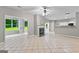 Open-concept living area with fireplace, tile floors, and natural light from large windows at 205 N Strathmore Dr, Sharpsburg, GA 30277