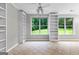 Bright living room features built-in shelving and large windows that bring the outdoors in at 205 N Strathmore Dr, Sharpsburg, GA 30277