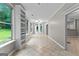 Bright living room featuring tile floors, built-in shelving, and large windows for natural light at 205 N Strathmore Dr, Sharpsburg, GA 30277
