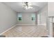 Bright living room features tile floors, neutral walls and large windows overlooking the backyard at 205 N Strathmore Dr, Sharpsburg, GA 30277