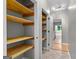 Open pantry featuring ample shelving and easy access to the kitchen area at 205 N Strathmore Dr, Sharpsburg, GA 30277