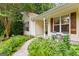 Charming front porch with seating area, lush landscaping, and a welcoming entrance at 205 N Strathmore Dr, Sharpsburg, GA 30277