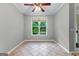 Bright room featuring tile flooring, a ceiling fan and a large window with outdoor views at 205 N Strathmore Dr, Sharpsburg, GA 30277