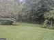 Spacious backyard with a lush lawn, bordered by mature trees providing ample shade and privacy at 1110 Hilburn Se Dr, Atlanta, GA 30316