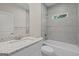Bright bathroom featuring granite countertop vanity and tub/shower combo with tiled walls at 55 Etheridge Rd, Temple, GA 30179