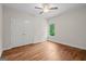Spare bedroom with hardwood floors, ceiling fan, window, and closet at 55 Etheridge Rd, Temple, GA 30179