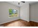 Cozy bedroom with hardwood floors, a large window with an outdoor view, and a closet at 55 Etheridge Rd, Temple, GA 30179