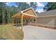 Attached carport with wooden support beams offering convenient covered parking near the home at 55 Etheridge Rd, Temple, GA 30179