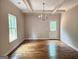 Classic dining room with hardwood floors, decorative ceiling beams, and a modern chandelier at 55 Etheridge Rd, Temple, GA 30179