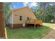 Side view of home featuring a wooden deck, green lawn, and well-maintained landscaping at 55 Etheridge Rd, Temple, GA 30179