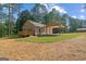 Exterior view of a home showing a well-maintained lawn and covered parking area at 55 Etheridge Rd, Temple, GA 30179