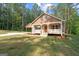 Home with a covered porch and matching carport, set on a beautiful lot with mature trees at 55 Etheridge Rd, Temple, GA 30179
