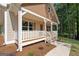 Inviting covered porch with white railings, showcasing a charming entrance with beautiful details at 55 Etheridge Rd, Temple, GA 30179