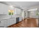 Bright kitchen with white cabinets, granite countertops, stainless steel appliances, and hardwood floors at 55 Etheridge Rd, Temple, GA 30179