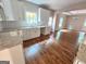 Bright kitchen featuring white cabinets, granite countertops, and stainless steel sink at 55 Etheridge Rd, Temple, GA 30179