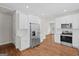Stylish kitchen with stainless steel refrigerator and appliances, white cabinetry, and hardwood floors at 55 Etheridge Rd, Temple, GA 30179