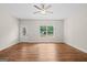 Bright living room featuring hardwood floors, a ceiling fan, and a window with backyard view at 55 Etheridge Rd, Temple, GA 30179