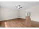 Spacious living room showcasing beautiful hardwood floors, a modern ceiling fan, and ample natural light at 55 Etheridge Rd, Temple, GA 30179