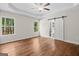 Main bedroom with hardwood floors, tray ceiling, and barn door leading to main bathroom at 55 Etheridge Rd, Temple, GA 30179