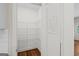 Walk-in pantry with shelving, painted door, and hardwood floors at 55 Etheridge Rd, Temple, GA 30179