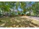 Large backyard with basketball court, grass, plants, and well-kept lawn at 15 Skipton Ct, Sharpsburg, GA 30277