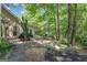 Secluded backyard area with patio, BBQ, and lush greenery for outdoor enjoyment at 15 Skipton Ct, Sharpsburg, GA 30277